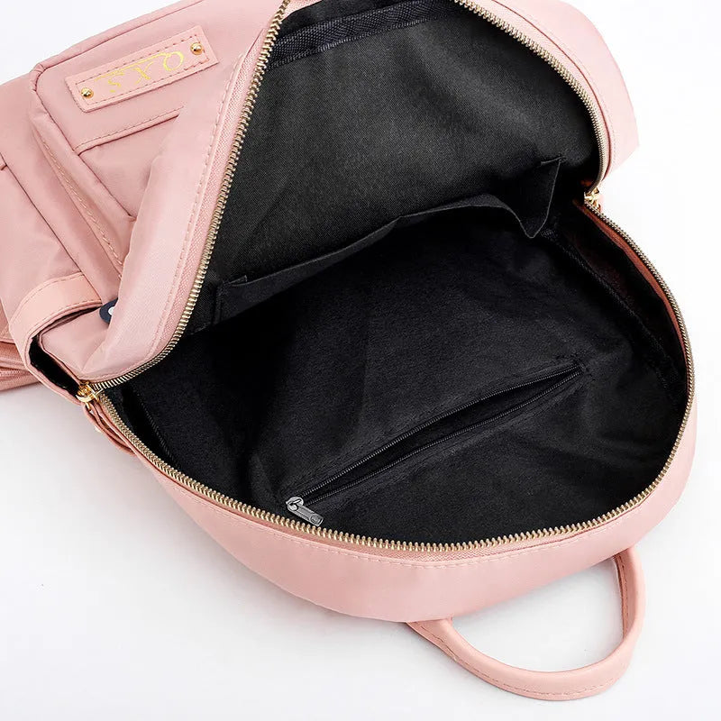 Women's black casual nylon backpack with shoulder straps showing external pockets and organised interior compartments