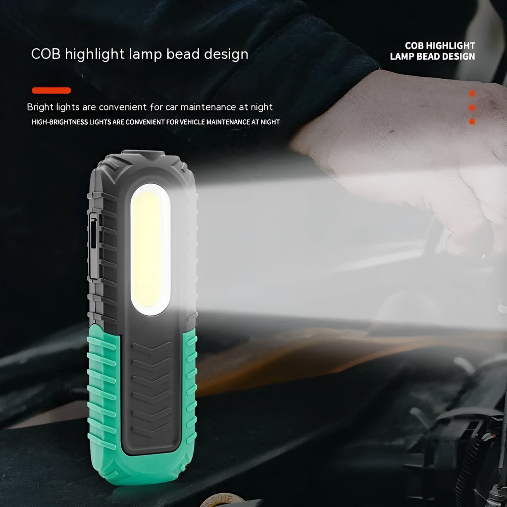 Black and green auto repair work light with USB charging port and clear lens