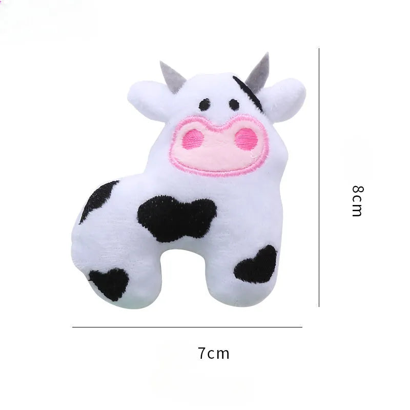 Soft plush cat toy shaped like a cow, a parrot, and a crocodile, each containing catnip for pet play.