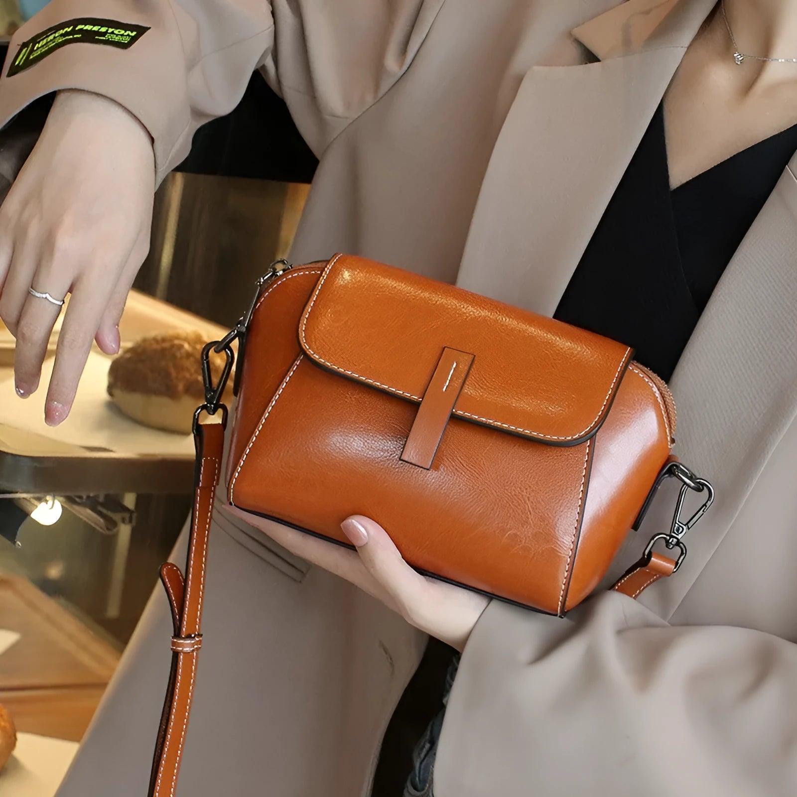 Women's brown oil wax leather messenger bag with crossbody strap and interior compartments