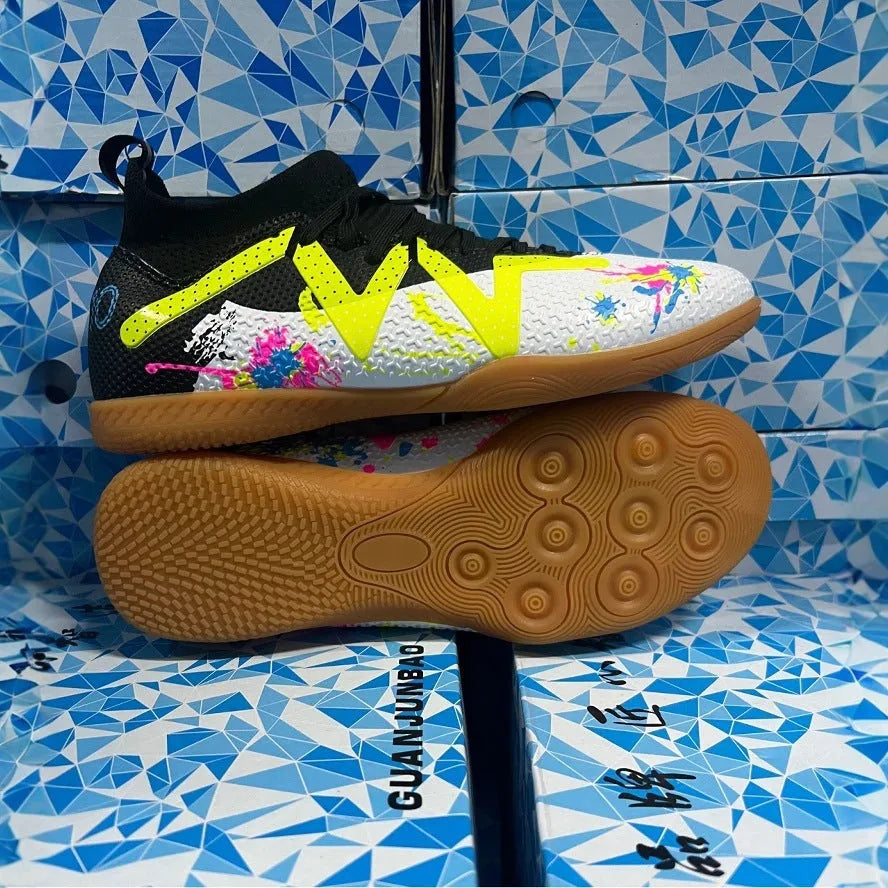 Adult low-top soccer shoes in black and yellow, showing studded rubber sole and printed PVC upper.
