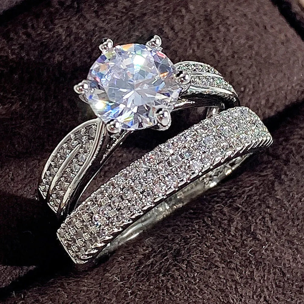 Simple geometric white gold colour alloy wedding ring bracelet on a plain background.