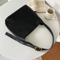 Two women's soft PU leather shoulder bags with swing threads, one black with ribbon and one brown with packet design
