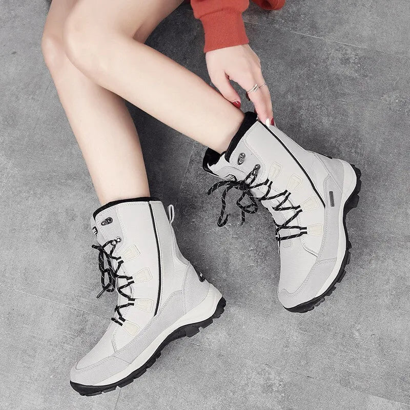 Women's mid-calf length black genuine leather thermal snow boots with a round toe and rubber sole