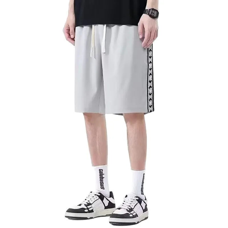 Men's black baggy track pants with loose fit and elasticated waist for casual sports wear