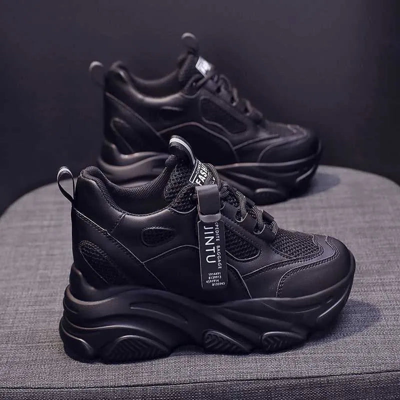 Men's black casual platform shoes with mesh upper and hollow out design on a white background.