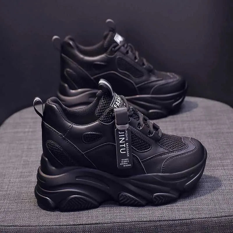 Men's black casual platform shoes with mesh upper and hollow out design on a white background.