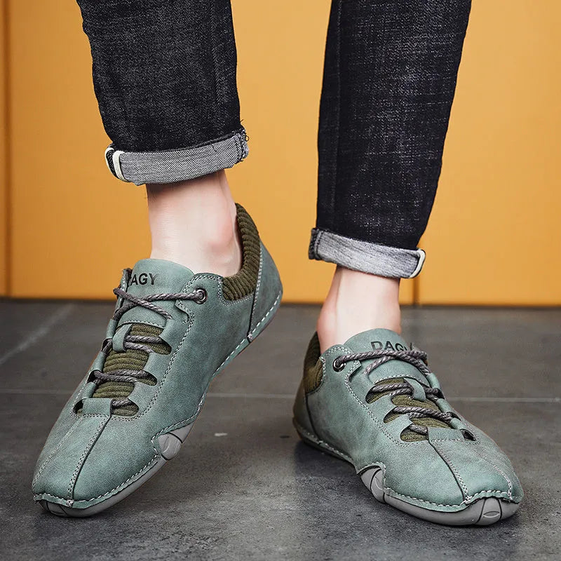 Men's solid colour lace-up casual sneakers with car stitching, blue upper, side view