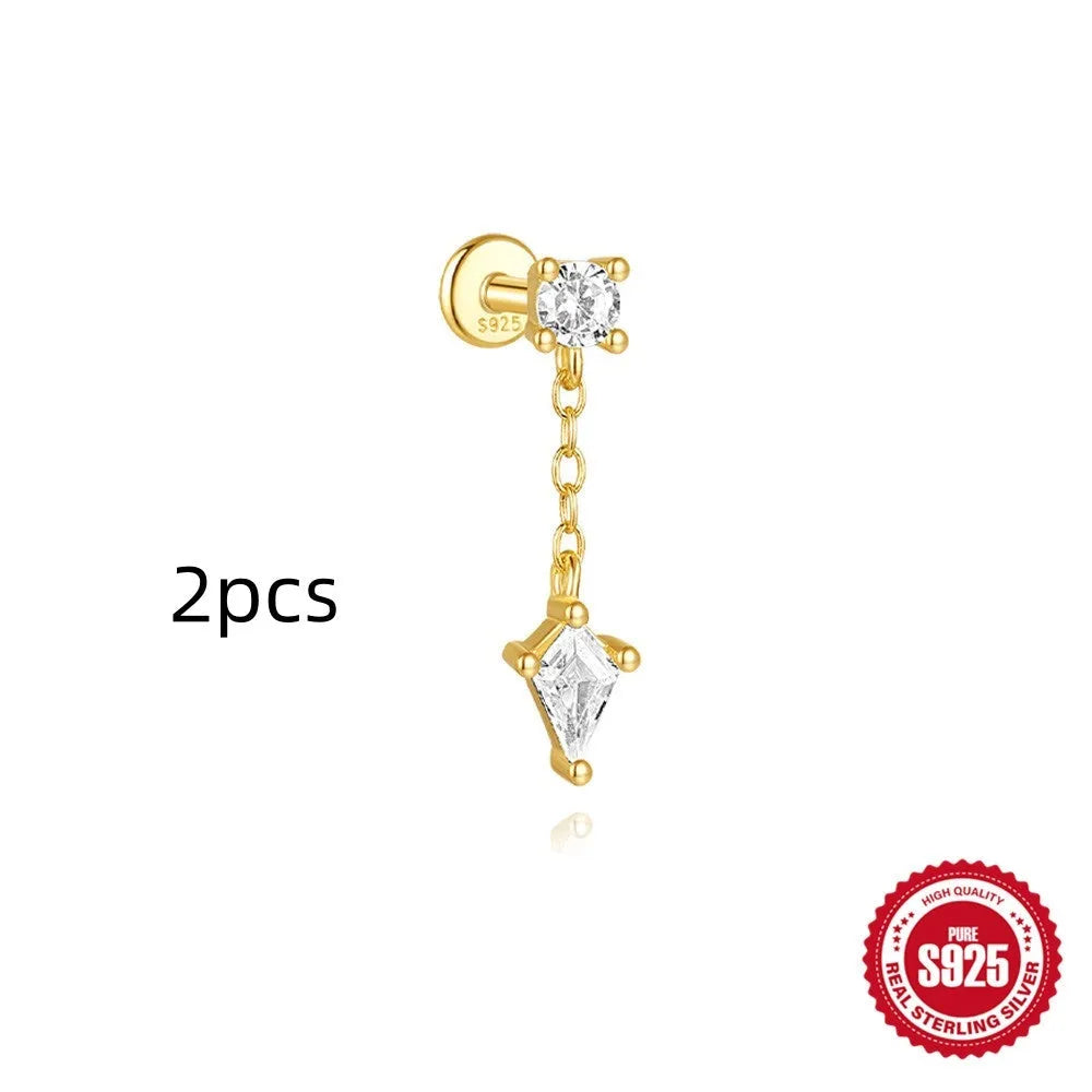 Geometric kite-shaped sterling silver stud earrings with rhinestones and a gold chain tassel.