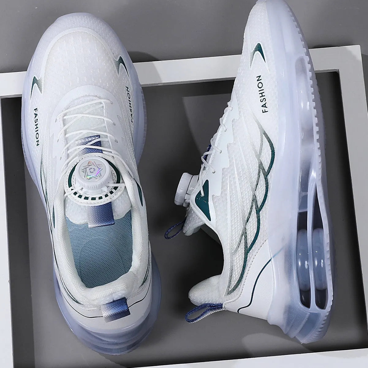 Men's white low-top casual sneakers with mesh upper, rotating button, and rubber sole.