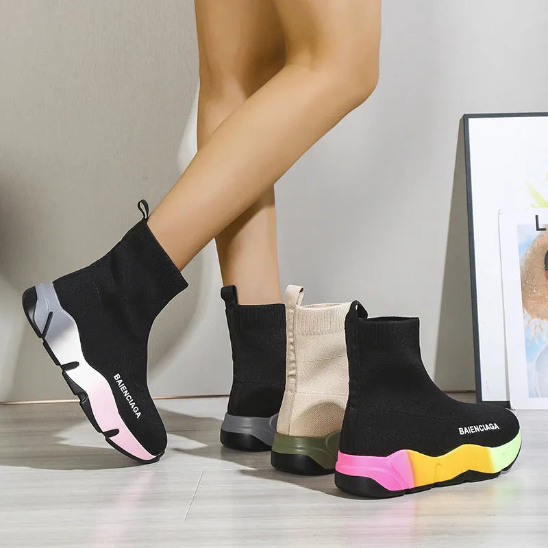 Women's black platform sock boots with cloth upper, rubber sole, round toe, thick heel, and low tube design on a neutral background