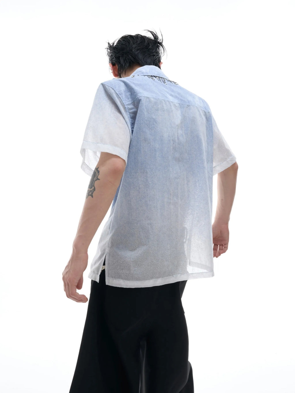 A loose-fit blue men's short sleeve shirt with a white gradient fade.