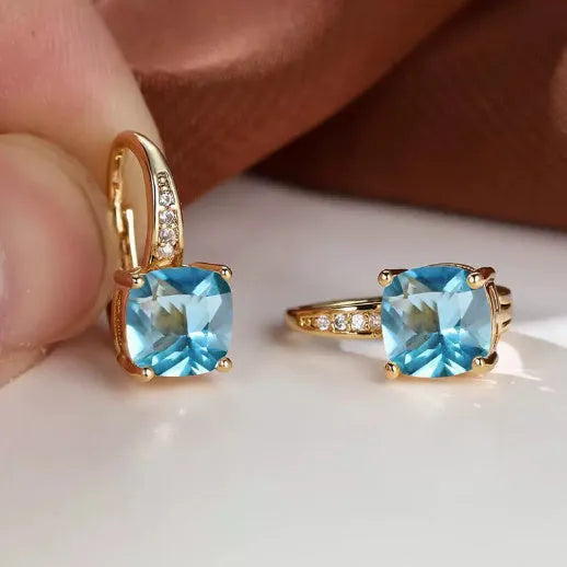 Square geometric ear clip with colourful moissanite inlay on an electroplated copper base.