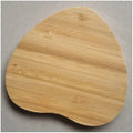 Brown wooden bamboo square 5W wireless charging pad on a desk.