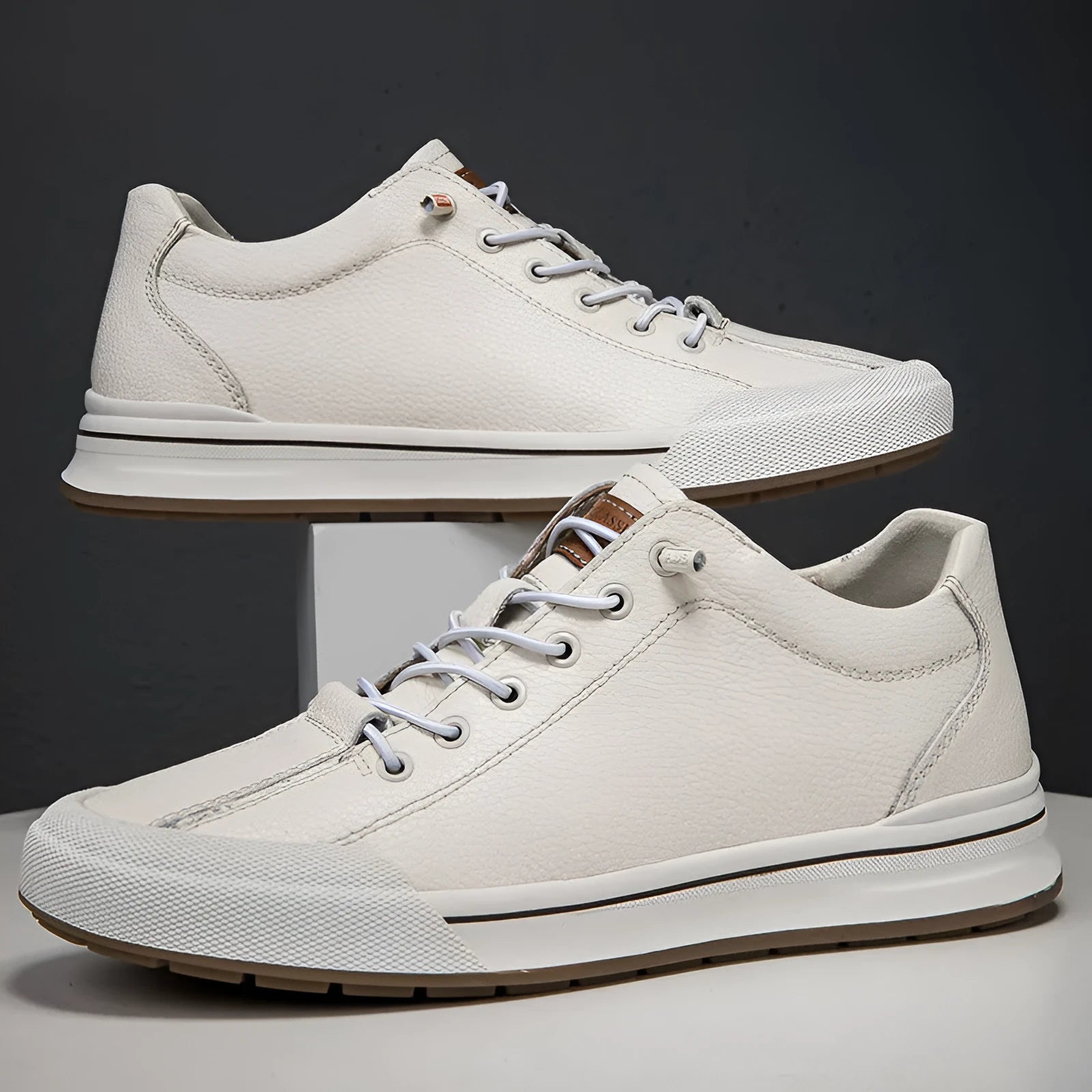 Men's white round toe matte leather casual shoes with flat heel on a plain background.