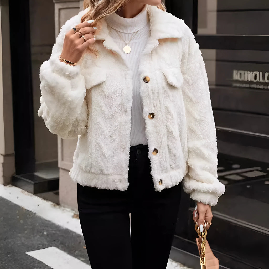 Ivory white women's cardigan coat with buttons and plush fabric on a hanger.