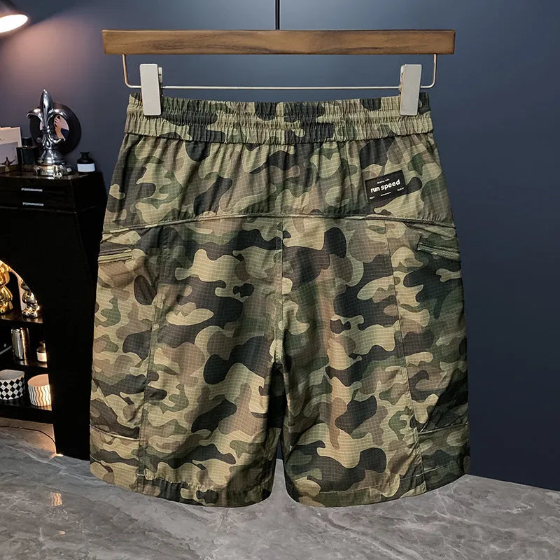 Man wearing loose-fit camouflage cargo shorts with multiple pockets, made from a cotton blend fabric.