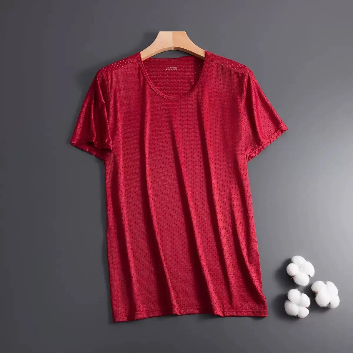 Men's solid colour ice silk short sleeve t-shirt on a hanger, showing loose crew neck and thin mesh fabric.