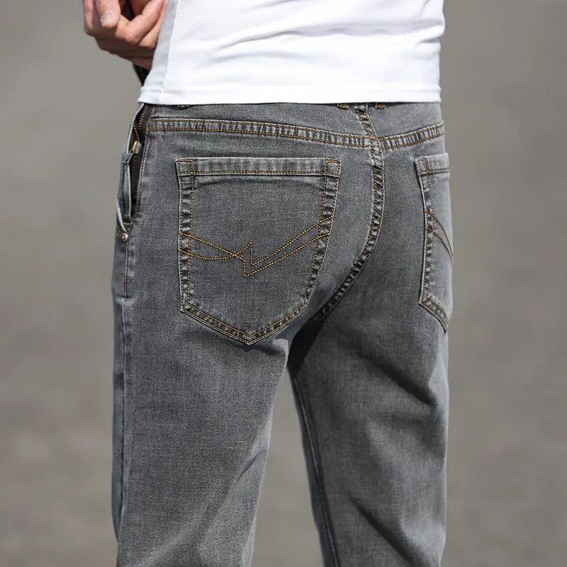 Men's straight-leg smoky gray jeans with low-rise waist and zip fly.