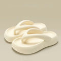 Solid colour EVA flip-flops with a thick sole and a decorative bow on the thong strap.