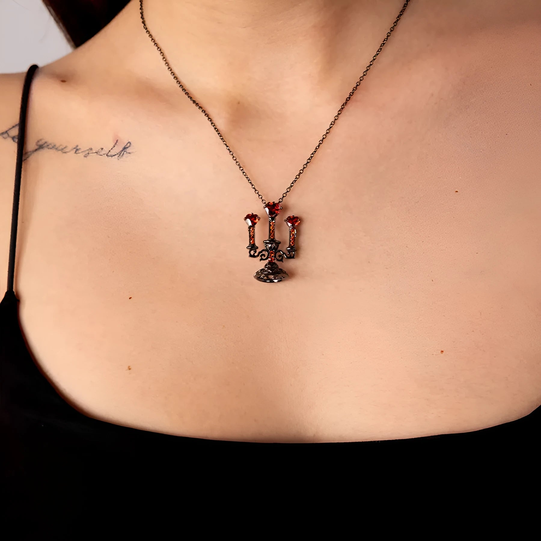 Close-up of a Gothic zinc alloy clavicle chain with a detailed hollow candlestick pendant on a cross chain.