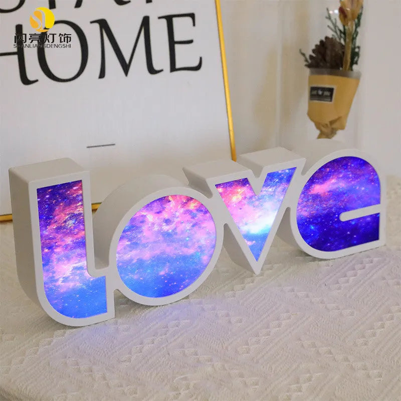 LED decorative light with rainbow-coloured LOVE word on plastic shade