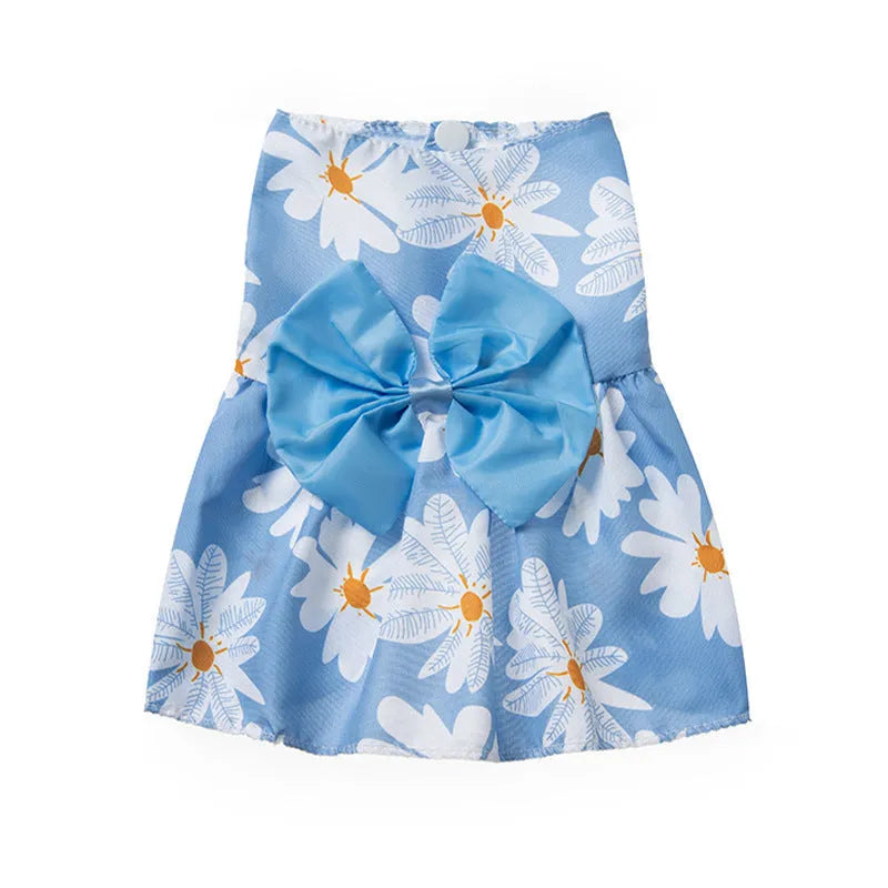 Orange floral butterfly pet dress with a bow on a dog, showing thin summer clothing.