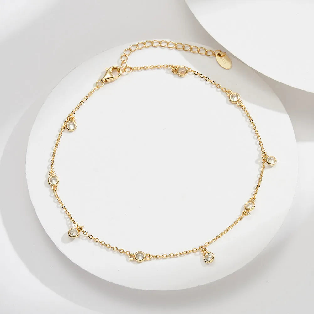 Women's sterling silver anklet with small geometric cubic zirconia pendant in gold or white gold finish.
