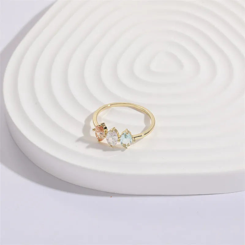 Geometric triangle ring with horse eye design and tricolour zircon stones in gold electroplated finish