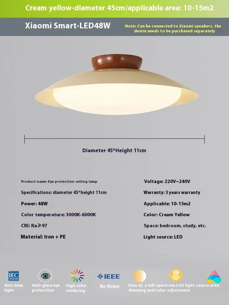 Modern minimalist cream style flying saucer ceiling lamp in mint green on a white ceiling.