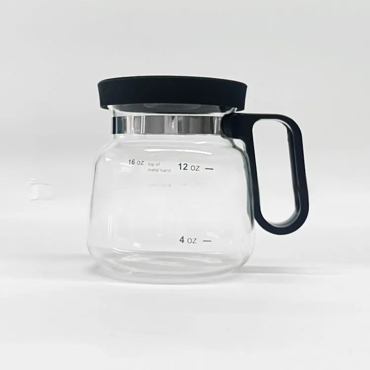 Transparent borosilicate glass pour-over coffee maker with a black silicone cover on a kitchen counter.
