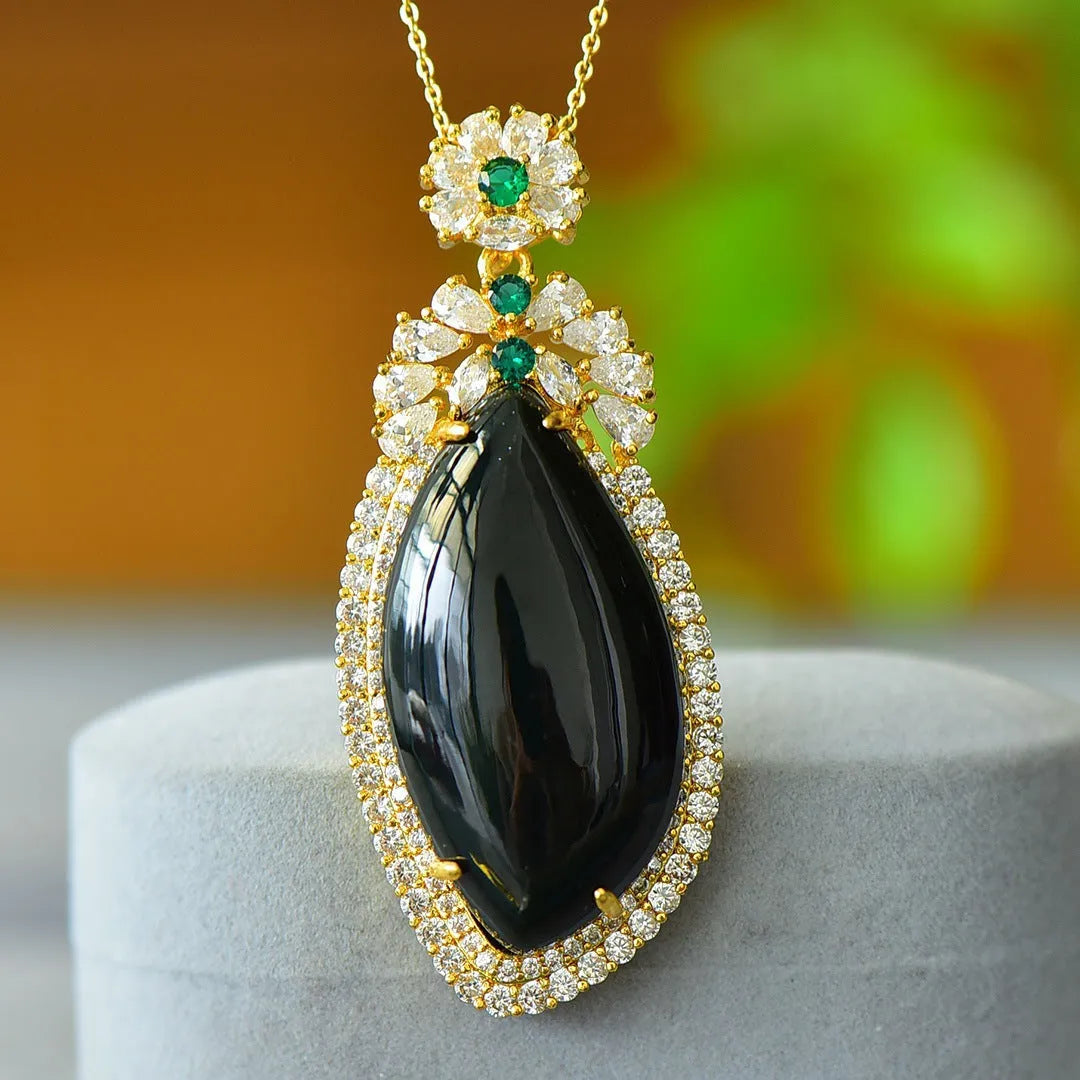 Close-up of a natural Hetian jade pendant with intricate copper inlay detail on a necklace chain.