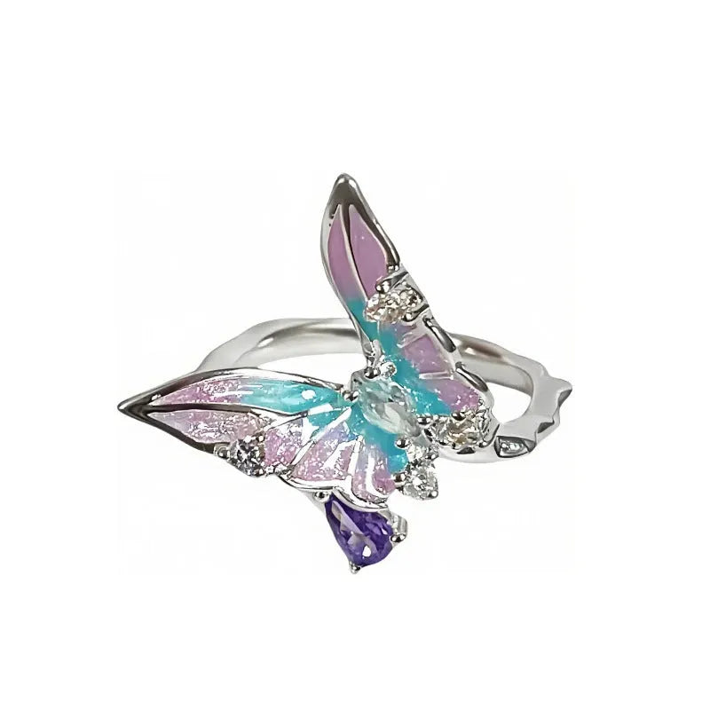 Adjustable copper fashion ring with modelled insect motif and metallic oil-finished surface.