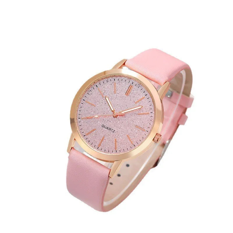 Women's pink quartz watch set with faux leather strap and bracelet on a light background