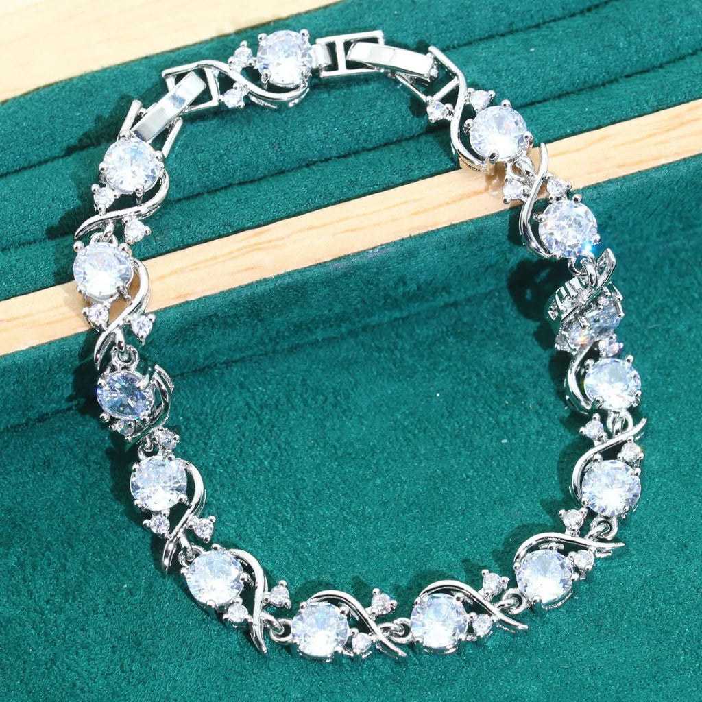 Four-piece bridal zircon jewellery set with necklace, earrings, bracelet and ring in water wave chain design