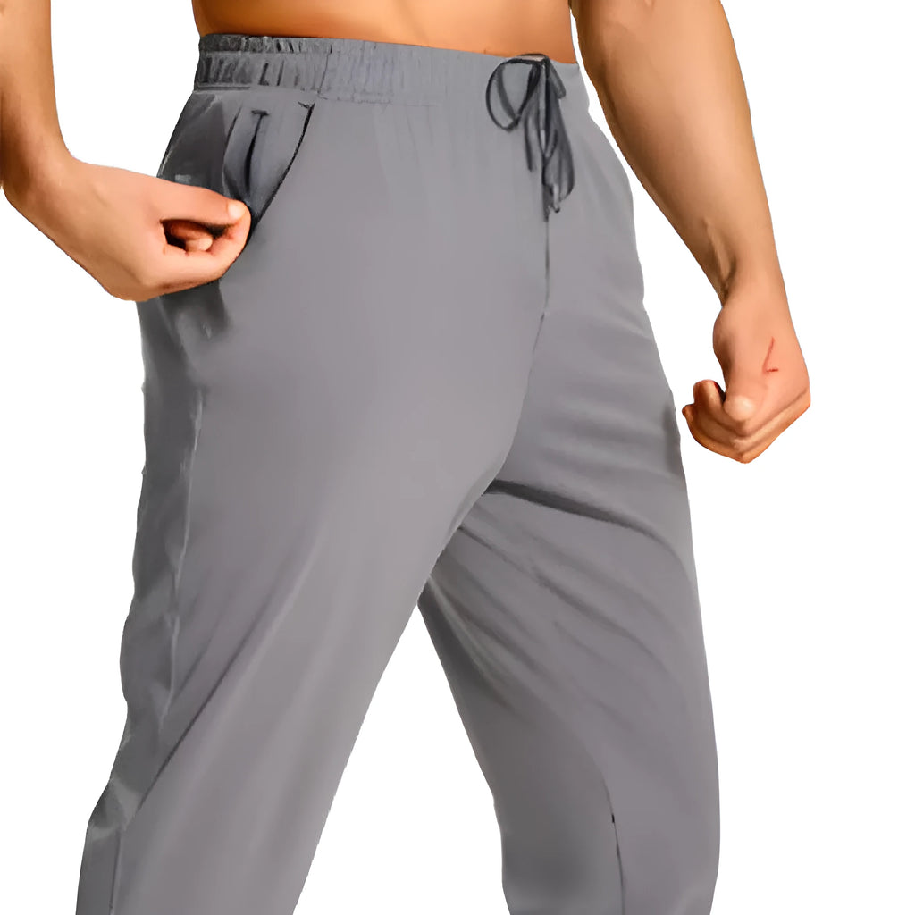 Men's solid colour loose casual trousers in polyester fabric on a hanger.