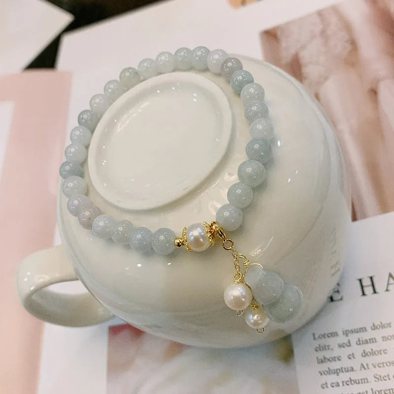 Chinese style jade bracelet with gourd design and pearl accents in natural emerald colour
