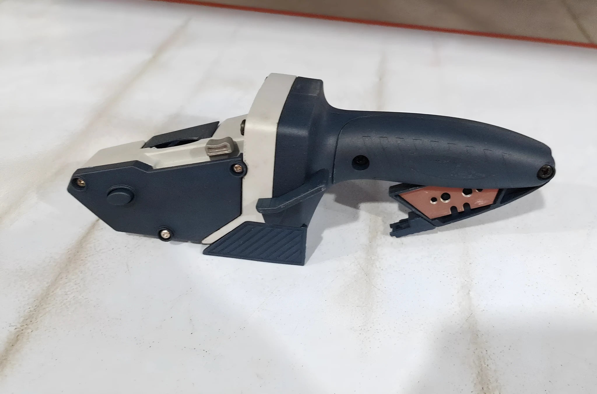Blue manual multifunctional cutter for dust-free cutting of gypsum board and foam board.