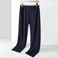 Man wearing black ice silk straight leg loose fit casual trousers with an elastic waistband