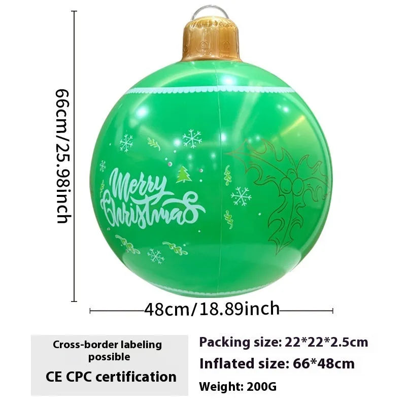Large red and white inflatable Christmas ball with flashing lights in a garden setting.