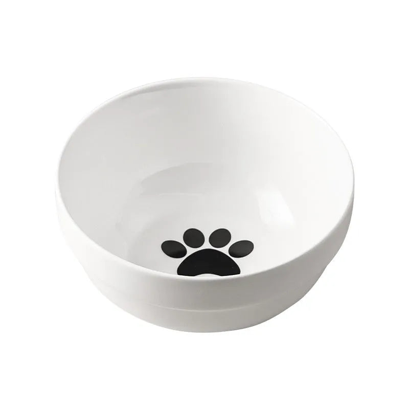 White ceramic pet bowl with cat footprints design in a black iron frame.