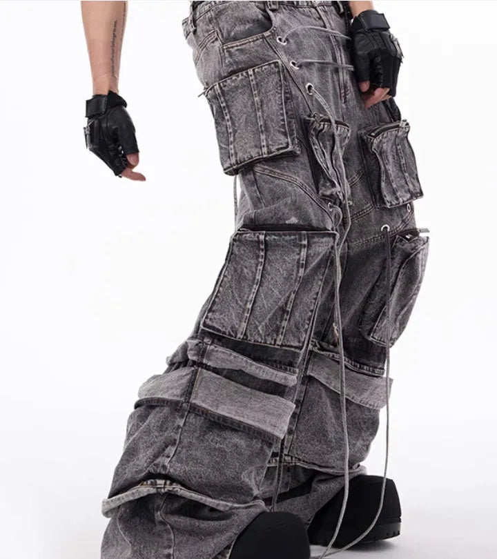 Grey distressed denim overalls with rope stitching detail on front