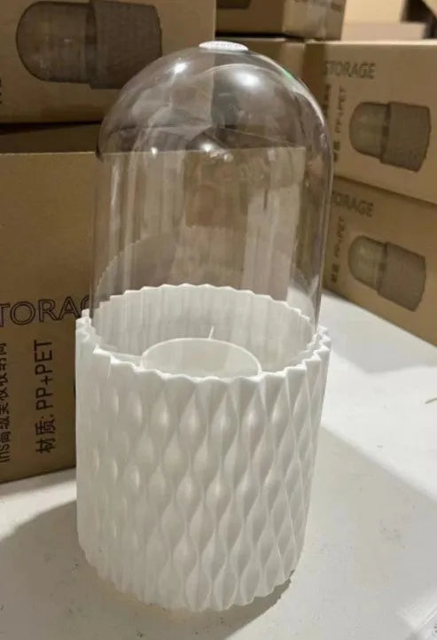 White rotating transparent makeup brush storage tube with dust cover lid on desktop