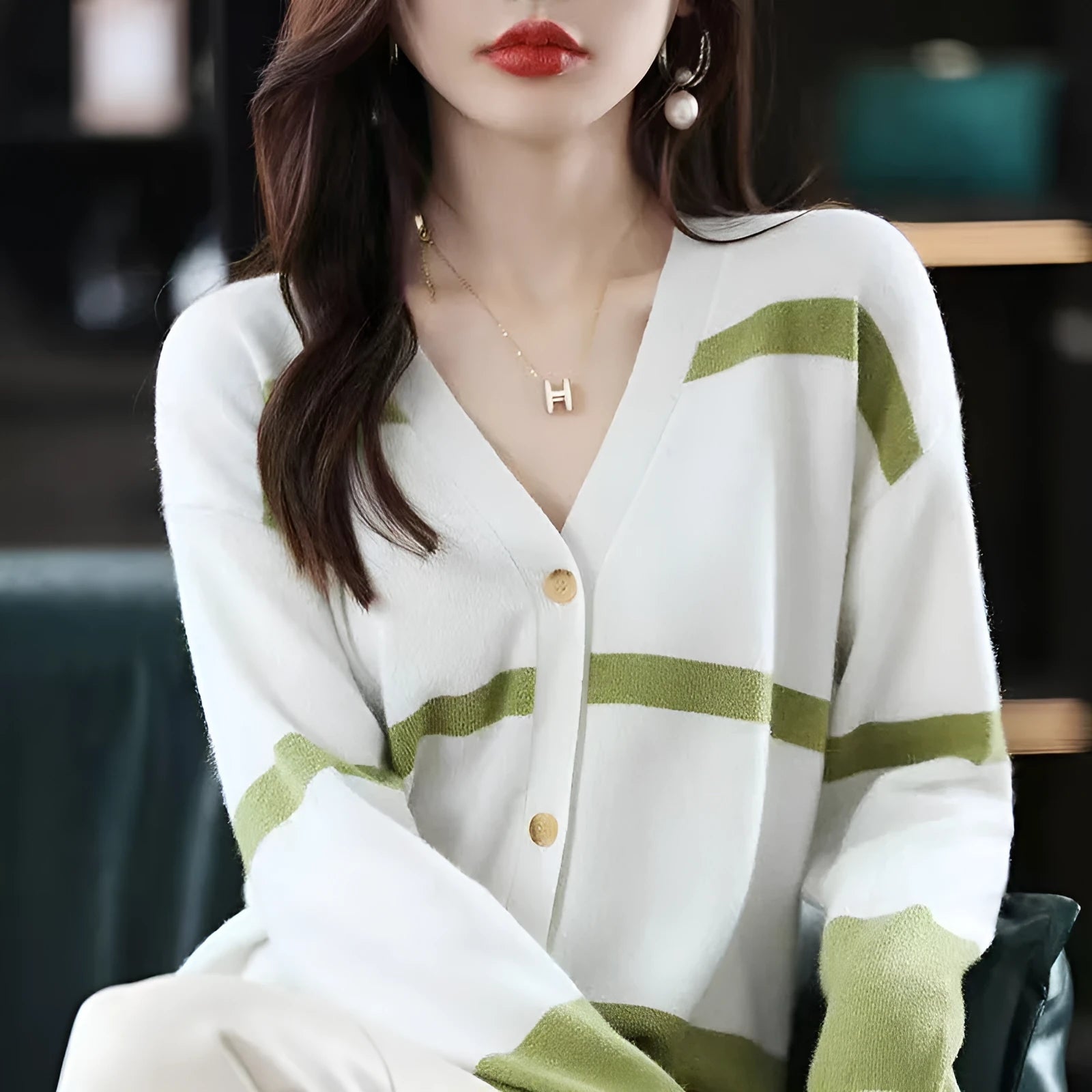 Women's striped V-neck knitted cardigan with 3D patterned sleeves and button front in a slim fit.