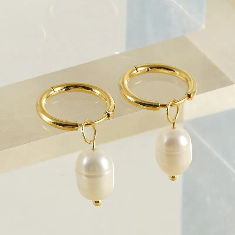 Gold geometric stainless steel earrings with pearl decorative elements and titanium posts