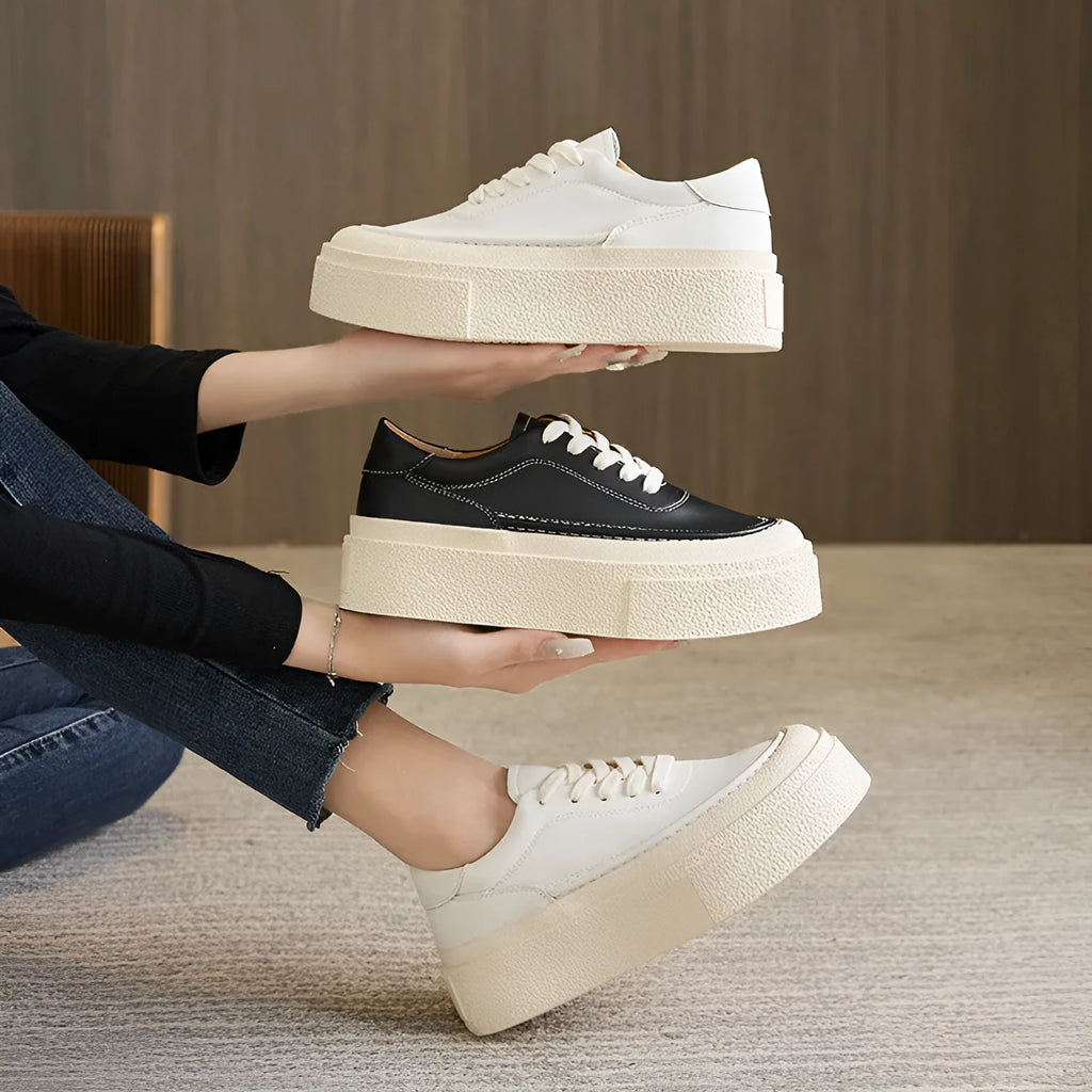 Women's black platform sports board shoes made from embossed cowhide leather with a rubber sole.