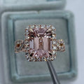 A geometric-shaped rose gold alloy ring on a plain background.