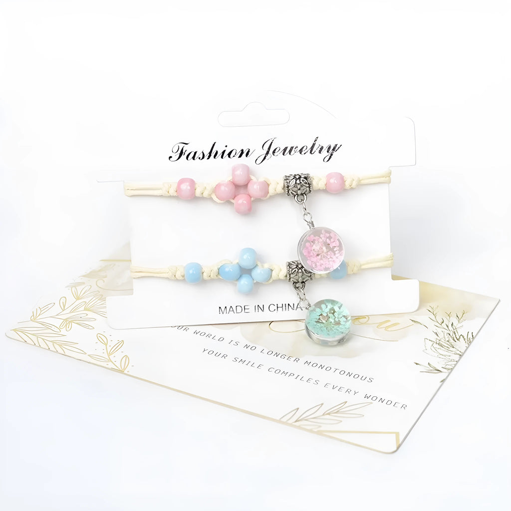 Close-up of a hand-woven glass bracelet with large beads containing real dried flowers and a lace design.