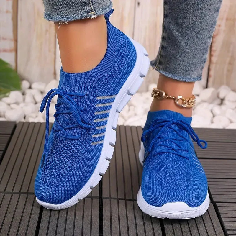 Women's breathable mesh flat shoes in various colours with front tie and round toe.