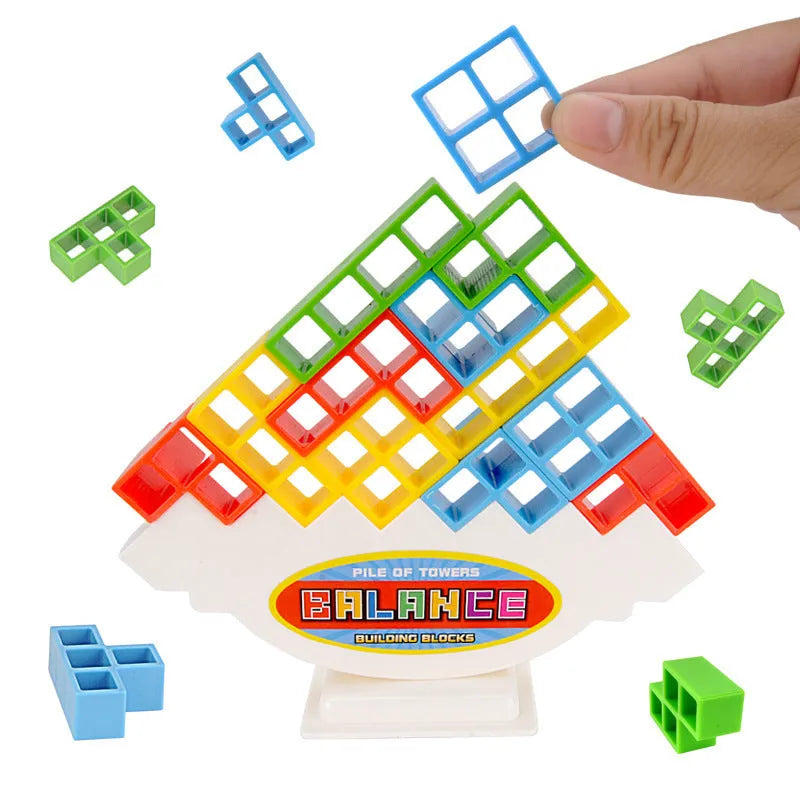 Plastic balance stacking board game with 16 coloured building blocks, chassis, and base on table.